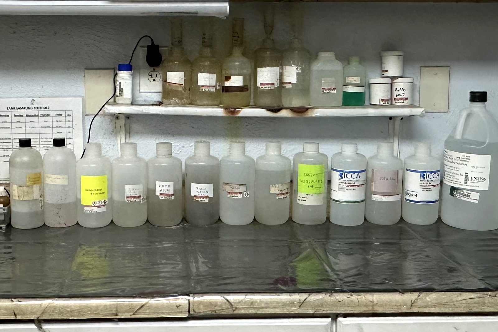 Labelled reagent and titration solutions on the Gleco Plating lab bench