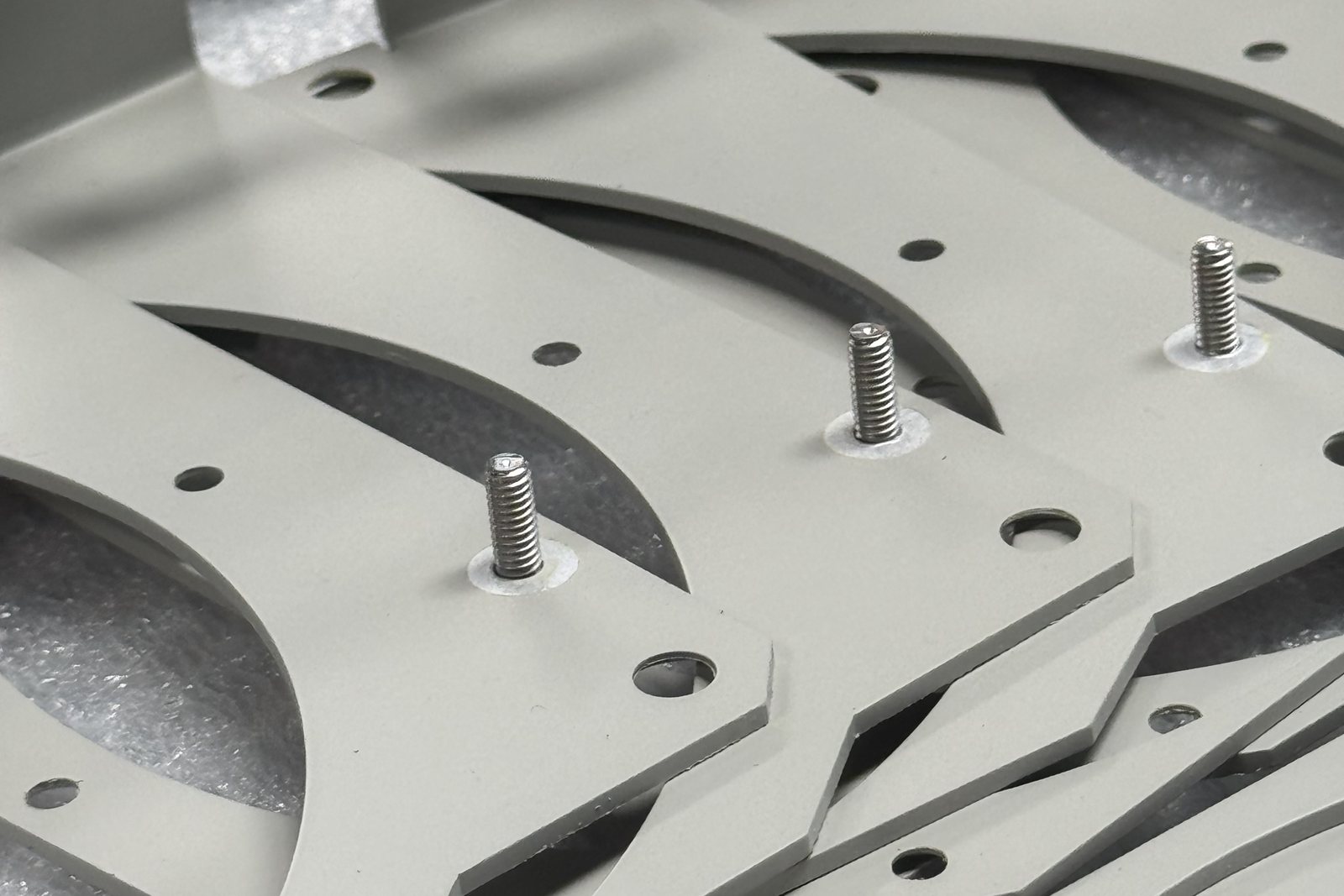 Powder coated brackets with masked threaded studs