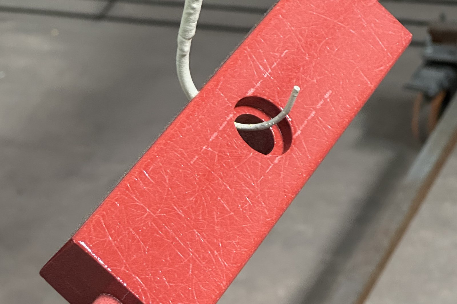 Red powder coated part on the coating line